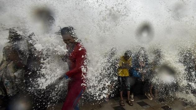 People drenched in waves hitting the shore during high tide at the Arabian Sea promenade, Worli Seaface in Mumbai, Maharashtra. (Kunal Patil / HT Photo)
