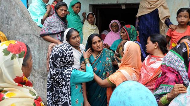 Mariyam Khatoon (C), widow of Alimuddin is surrounded by villagers demanding justice after Alimuddin was lynched by a mob for allegedly carrying beef in his van at Manuwa village in Ramgarh, Jharkhand. (Parwaz Khan / HT Photo)
