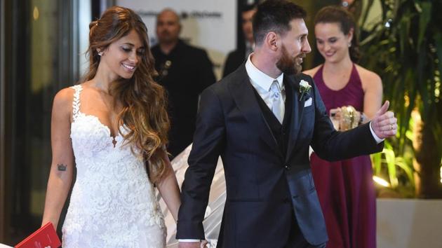 Argentine football star Lionel Messi and bride Antonella Roccuzzo pose for photographers just after their wedding. (AFP)