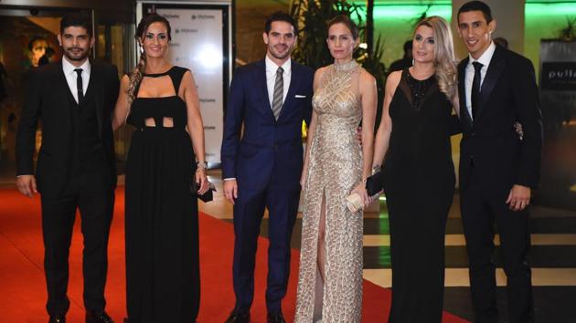 Paris Saint Germain's footballer Angel di Maria (R), Boca Juniors' footballer Fernando Gago (C) and Sevilla's footballer Ever Banegas pose with their wives. (AFP)