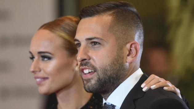 FC Barcelona player Jordi Alba and his wife pose on a red carpet during Lionel Messi and Antonella Roccuzzo’s wedding in Rosario. (AFP)