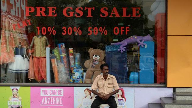 A security guard sits in shop giving discounts ahead of the Goods and Services Tax (GST) in Chennai, Tamil Nadu . (Arun Sankar /AFP)