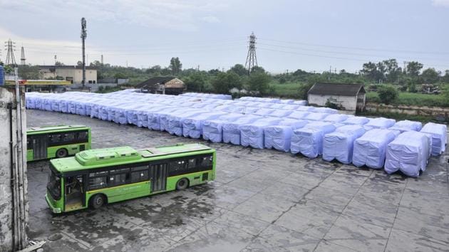Buses covered with plastic covers to avoid damage during the a pre-monsoon shower at Indraprastha Bus Depot in New Delhi, India. (Arun Sharma / HT Photo)