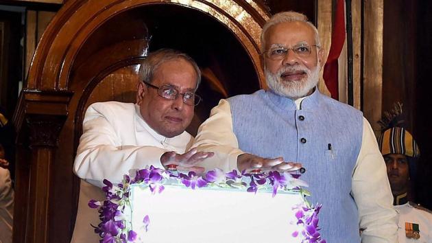 President Pranab Mukherjee and PM Narendra Modi press buttons for the launch of Goods and Services Tax (GST) at midnight, at the special ceremony in the Central Hall of Parliament in New Delhi.(PTI Photo)
