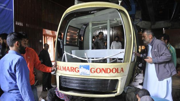 Officials check the damaged gondola in which four tourists, including two children as well as three locals died when a cable car came crashing down after being hit by an uprooted tree after strong winds at Gulmarg tourist resort in Jammu & Kashmir. (Waseem Andrabi / HT Photo)