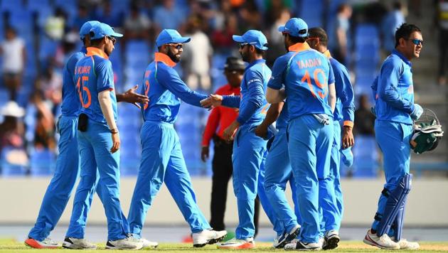 India captain Virat Kohli (C) celebrates with teammates after defeating West Indies at the end of the third ODI at the Sir Vivian Richards Cricket Ground in St. John's, Antigua.(AFP)