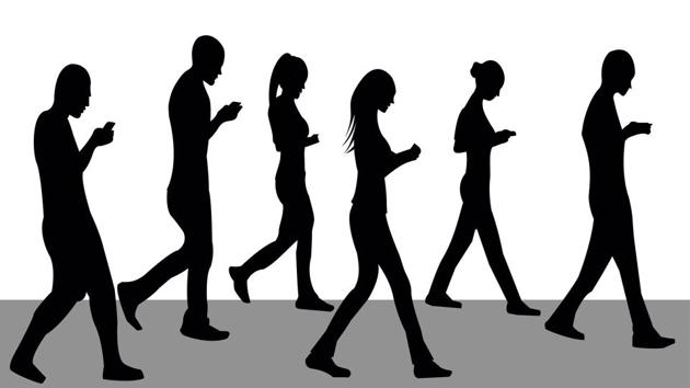 Participants wore a mobile eye tracker and motion analysis sensors and walked towards and then stepped over a floor-based object, which was a similar height to a roadside kerb, while writing a text.(Shutterstock)