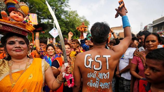 A Hindu devotee shows his painted back with a message reading ‘GST (Global Service Tax) - A new boon or a lasting burden?’ ahead of the roll-out of the new tax in India, during the annual Rath Yatra or chariot procession, in Ahmedabad. (Amit Dave / Reuters)