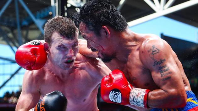 Manny Pacquiao (R) of the Philippines fight Jeff Horn (L) of Australia during the World Boxing Organization bout.(AFP)
