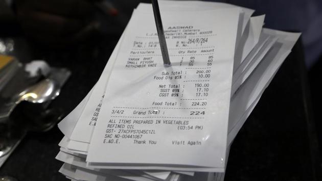 A bill is clumped together with others at a restaurant with the new Goods and Services Tax (GST) added to it, in Mumbai.(AP Photo)