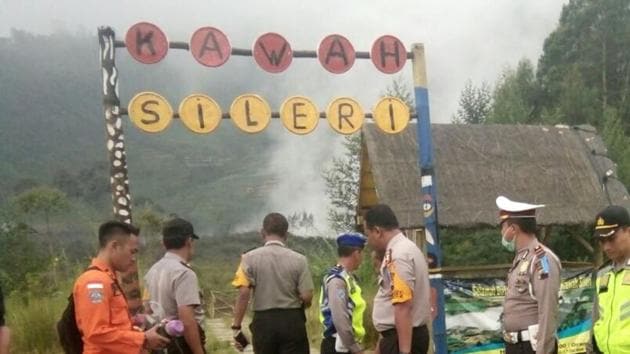 Police officers and a rescuer stand at a path leading to Sileri Crater after it erupted in Dieng, Central Java, Indonesia on July 2. (AP Photo) Police officers and a rescuer stand at a path leading to Sileri Crater after it erupted in Dieng, Central Java, Indonesia on July 2. (AP Photo)