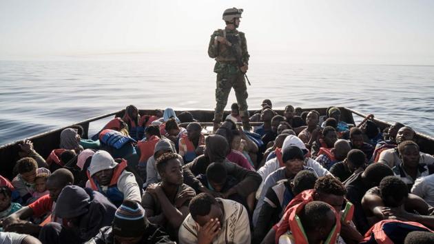 A Libyan coast guardsman stands on a boat during the rescue of 147 illegal immigrants attempting to reach Europe off the coastal town of Zawiyah, 45 kilometres west of the capital Tripoli, Libya. (Taha Jawashi / AFP) A Libyan coast guardsman stands on a boat during the rescue of 147 illegal immigrants attempting to reach Europe off the coastal town of Zawiyah, 45 kilometres west of the capital Tripoli, Libya. (Taha Jawashi / AFP)