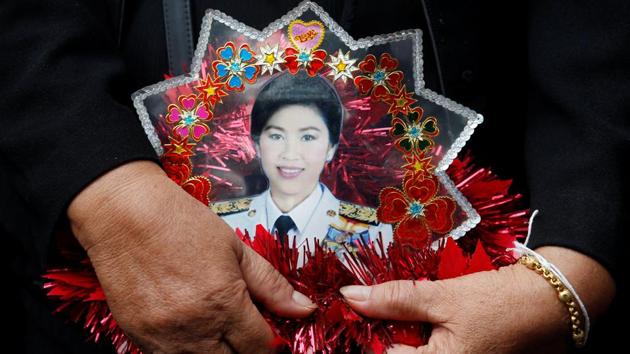 A supporter of ousted former Thai Prime Minister Yingluck Shinawatra holds a picture of Yingluck while waiting for former PM Yingluck's arrival at the Supreme Court in Bangkok, Thailand June 29, 2017. (Chaiwat Subprasom / Reuters) A supporter of ousted former Thai Prime Minister Yingluck Shinawatra holds a picture of Yingluck while waiting for former PM Yingluck's arrival at the Supreme Court in Bangkok, Thailand June 29, 2017. (Chaiwat Subprasom / Reuters)