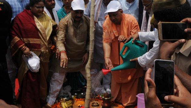 UP chief minister Yogi Adityanath planting a sapling in Nakshatra Vatika at Kukrail picnic spot in Lucknow, on Saturday.(Subhankar Chakraborty/HT Photo)