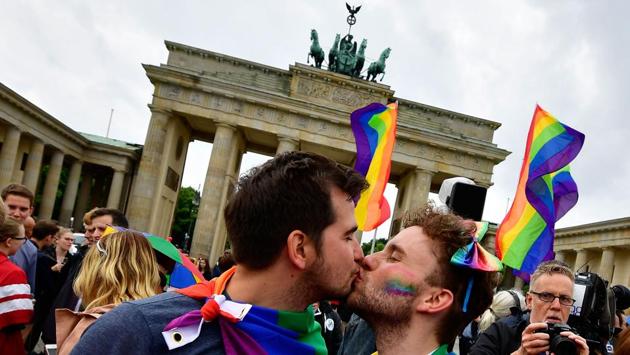 Two men kiss as they attend a rally of gays and lesbians in front of the Brandenburg Gate in Berlin, Germany. The German parliament legalised same-sex marriage, days after Chancellor Angela Merkel said she would allow her conservative lawmakers to follow their conscience in the vote. (Tobias Schwarz / AFP) Two men kiss as they attend a rally of gays and lesbians in front of the Brandenburg Gate in Berlin, Germany. The German parliament legalised same-sex marriage, days after Chancellor Angela Merkel said she would allow her conservative lawmakers to follow their conscience in the vote. (Tobias Schwarz / AFP)
