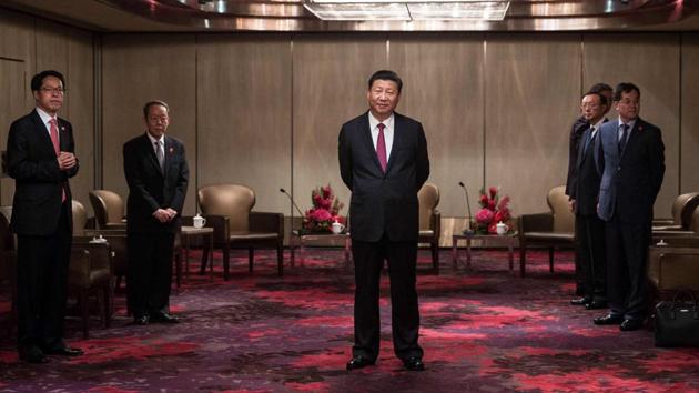 China's President Xi Jinping (C) waits to meet with Hong Kong's chief executive Leung Chun-ying at a hotel in Hong Kong as part of the 20th anniversary of the city's handover from British to Chinese rule. (Dale De La Rey / AFP) China's President Xi Jinping (C) waits to meet with Hong Kong's chief executive Leung Chun-ying at a hotel in Hong Kong as part of the 20th anniversary of the city's handover from British to Chinese rule. (Dale De La Rey / AFP)