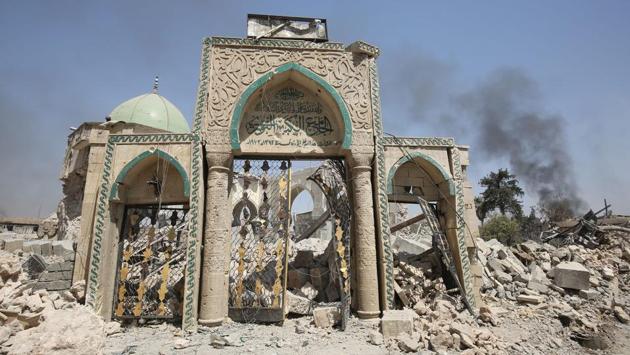 A view of the destroyed gate of the Al-Nuri Mosque in the Old City of Mosul, as Iraqi government forces continue their offensive to retake the city from Islamic State (IS) group . IS blew up the mosque and the famed Al-Hadba (hunchback) leaning minaret on June 21 as Iraqi forces closed in. (Ahmad Al Rubaye / AFP) A view of the destroyed gate of the Al-Nuri Mosque in the Old City of Mosul, as Iraqi government forces continue their offensive to retake the city from Islamic State (IS) group . IS blew up the mosque and the famed Al-Hadba (hunchback) leaning minaret on June 21 as Iraqi forces closed in. (Ahmad Al Rubaye / AFP)