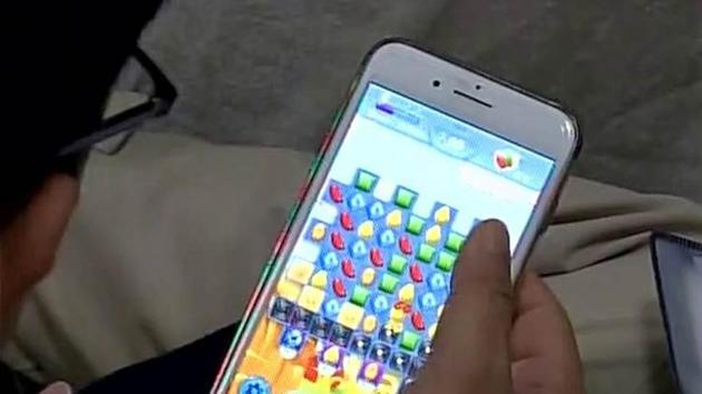 A police officer playing the Candy Crush Saga game on his mobile phone. (ANI file photo) A police officer playing the Candy Crush Saga game on his mobile phone. (ANI file photo)