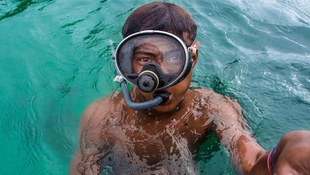 Some of them breathe through thin plastic tubes hooked up to compressors, while others use no equipment. Many suffer decompression sickness, which can leave them crippled and unable to walk. (Ye Aung THU / AFP)