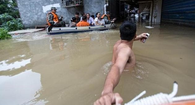 Rescuers row as they transfer residents with a boat at a flooded area in Guilin, Guangxi province, China on July 2. (Reuters) Rescuers row as they transfer residents with a boat at a flooded area in Guilin, Guangxi province, China on July 2. (Reuters)