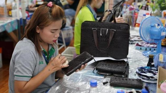 A worker polishes a wallet made from crocodile skin at Sri Ayuthaya Crocodile farm. (Athit Perawongmetha / Reuters) 