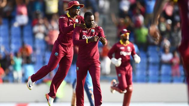 West Indies' Kesrick Williams (C) celebrates with teammates after dismissing India's MS Dhoni. (AFP) West Indies' Kesrick Williams (C) celebrates with teammates after dismissing India's MS Dhoni. (AFP)