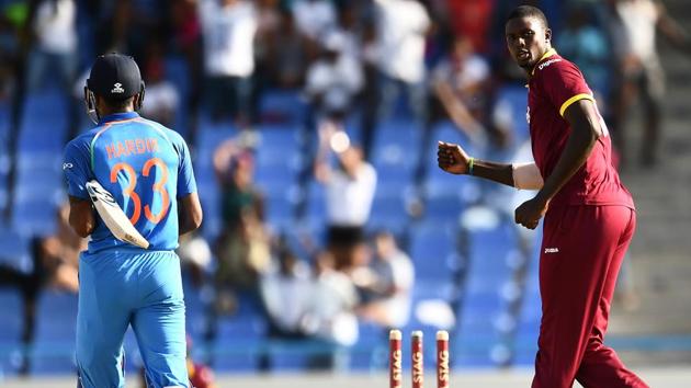 West Indies' captain Jason Holder (R) celebrates after bowling out India's Hardik Pandya during the fourth One Day International (ODI) match. View highlights of India vs West Indies, 4th ODI here(AFP)