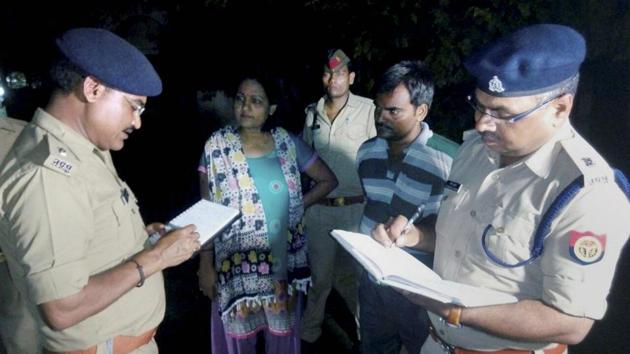 Lucknow: UP Police officers interacting with relatives of a 35-year-old woman who was attacked with acid, in Lucknow on Sunday. (PTI) Lucknow: UP Police officers interacting with relatives of a 35-year-old woman who was attacked with acid, in Lucknow on Sunday. (PTI)