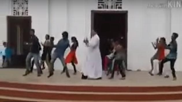 A screengrab of a Kerala priest in traditional white robes seen dancing in a flash mob. (Youtube) A screengrab of a Kerala priest in traditional white robes seen dancing in a flash mob. (Youtube)