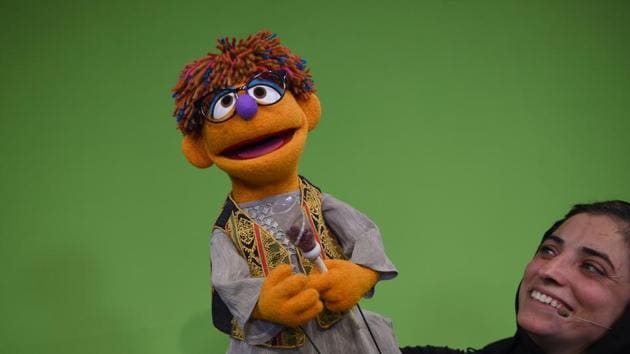 Afghan puppeteers Seema Sultani holds the new Sesame Street Muppet Zeerak during a recording at a television studio in Kabul.(AFP)