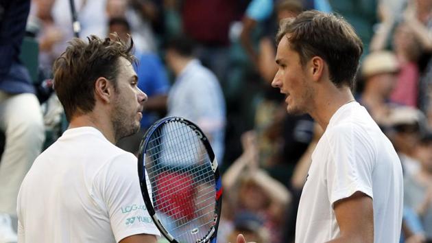 Russia's Daniil Medvedev, right, after winning his men's singles match against Switzerland's Stan Wawrinka, on the opening day at the Wimbledon Tennis Championships in London on Monday.(AP)