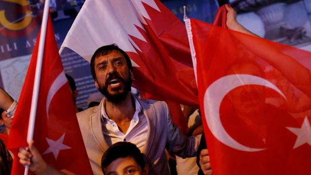 People shout slogans as they hold Turkish and Qatari flags during a demonstration in favour of Qatar in central Istanbul. Qatar has also been asked to reduce trade ties with Iran in line with the current US sanctions on the country which may prove difficult owing to the Qatar-Iran shared offshore natural gas field that supplied the former nation. (Murad Sezer / Reuters) People shout slogans as they hold Turkish and Qatari flags during a demonstration in favour of Qatar in central Istanbul. Qatar has also been asked to reduce trade ties with Iran in line with the current US sanctions on the country which may prove difficult owing to the Qatar-Iran shared offshore natural gas field that supplied the former nation. (Murad Sezer / Reuters)