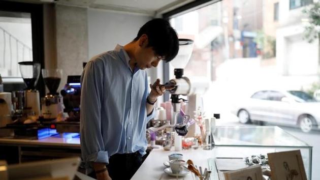 He started brewing coffee at age 17, during his mandatory military service and enjoyed it so much that he bought a coffee machine and opened his first cafe for fellow soldiers in his camp near the border with North Korea. (Kim Hong-Ji N / Reuters) He started brewing coffee at age 17, during his mandatory military service and enjoyed it so much that he bought a coffee machine and opened his first cafe for fellow soldiers in his camp near the border with North Korea. (Kim Hong-Ji N / Reuters)