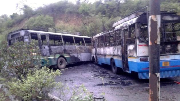 Two buses caught fire after collision at Damtal in Kangra district on Tuesday. (HT Photo)