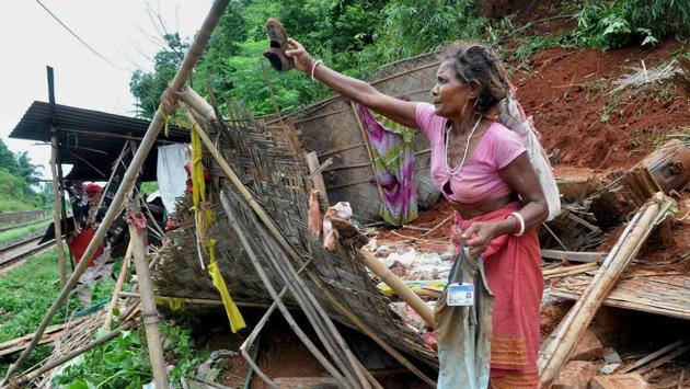 A woman showing a shoe of her 7-yr-old grand-daughter who was buried alive in a landslide at Panikhaiti in Kamrup district of Assam. (PTI)