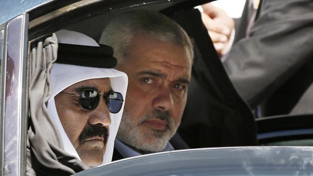 Former Emir of Qatar Sheikh Hamad bin Khalifa al-Thani (L), and Gaza's Hamas prime minister Ismail Haniyeh, arrive for a corner-stone laying ceremony for Hamad, a new residential neighborhood in Khan Younis, Gaza. Qatar has invested hundreds of millions of dollars in infrastructure in Hamas-ruled Gaza, but its role as one of the few foreign backers of the internationally shunned Islamic militant group could is a major issue of contention as Qatar faces pressure from its Gulf neighbours to cut these ties. (Mohammed Salem / AP File) Former Emir of Qatar Sheikh Hamad bin Khalifa al-Thani (L), and Gaza's Hamas prime minister Ismail Haniyeh, arrive for a corner-stone laying ceremony for Hamad, a new residential neighborhood in Khan Younis, Gaza. Qatar has invested hundreds of millions of dollars in infrastructure in Hamas-ruled Gaza, but its role as one of the few foreign backers of the internationally shunned Islamic militant group could is a major issue of contention as Qatar faces pressure from its Gulf neighbours to cut these ties. (Mohammed Salem / AP File)