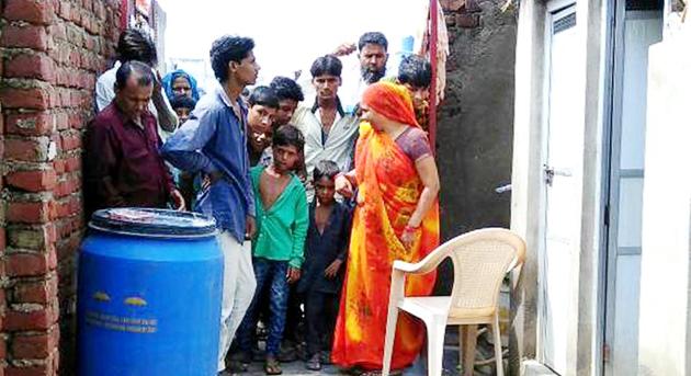 Neighbours outside the house of Kamlesh in Khori Kalan village in Mewat on Tuesday. (HT Photo) Neighbours outside the house of Kamlesh in Khori Kalan village in Mewat on Tuesday. (HT Photo)