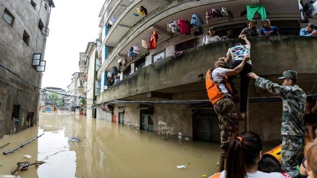 Rescuers transfer residents on a boat in the flooded area in Guangxi province, China. (REUTERS) Rescuers transfer residents on a boat in the flooded area in Guangxi province, China. (REUTERS)