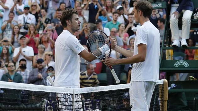 Russia's Daniil Medvedev (R)stunned Switzerland's Stan Wawrinka 6-4, 3-6, 6-4, 6-1 in their first round match at Wimbledon on Monday. (AFP)