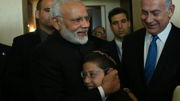 Prime Minister Narendra Modi with 2008 Mumbai terror attacks survivor Moshe Holtzberg.(Twitter/@MEAIndia)