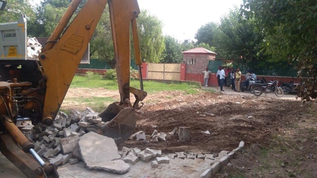 llegal road leading to senior Congress leader Charanjit Singh Channi being demolished by Chandigarh MC staff.(HT Photo)