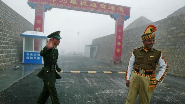 A photograph from July 10, 2008, shows a Chinese soldier (left) and an Indian soldier standing guard at the Chinese side of the Nathu La border crossing between India and China. (AFP/Getty Images) A photograph from July 10, 2008, shows a Chinese soldier (left) and an Indian soldier standing guard at the Chinese side of the Nathu La border crossing between India and China. (AFP/Getty Images)