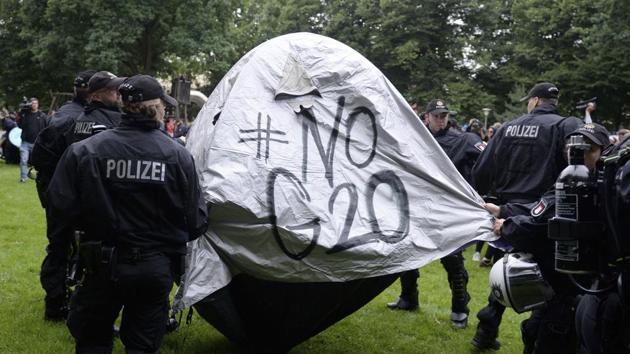 Police officers remove a protestors' tent as they clear a camp at Emil Wendt Park in Hamburg, northern Germany, on July 4, 2017. (AP Photo) Police officers remove a protestors' tent as they clear a camp at Emil Wendt Park in Hamburg, northern Germany, on July 4, 2017. (AP Photo)