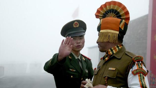 In this photograph taken on July 10, 2008, a Chinese soldier gestures as he stands near an Indian soldier on the Chinese side of the ancient Nathu La border crossing between India and China. (AFP Photo) In this photograph taken on July 10, 2008, a Chinese soldier gestures as he stands near an Indian soldier on the Chinese side of the ancient Nathu La border crossing between India and China. (AFP Photo)
