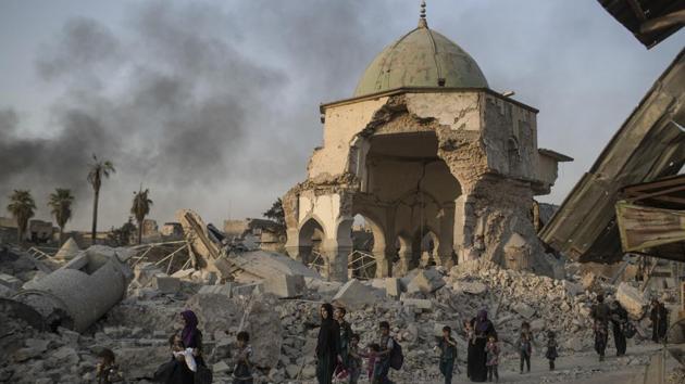 Fleeing Iraqi civilians walk past the heavily damaged al-Nuri mosque as Iraqi forces continue their advance against Islamic State militants in the Old City of Mosul, Iraq. As Iraqi forces continued to advance on the last few hundred square kilometers of Mosul held by the Islamic State group, the country's Prime Minister said Tuesday the gains show Iraqis reject terrorism. (AP)
