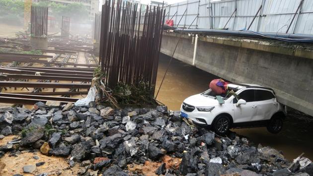 A damaged car is seen under a bridge after a flood in Quanzhou County, in Guilin, Guangxi province. (REUTERS) A damaged car is seen under a bridge after a flood in Quanzhou County, in Guilin, Guangxi province. (REUTERS)