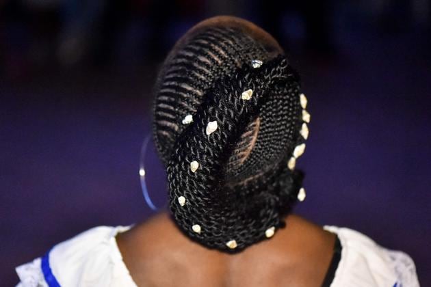 The Afro-Colombian hairstyles have origins from the times of slavery, when women would sit to comb their children’s hair after a backbreaking day of labour. (LUIS ROBAYO / AFP) 