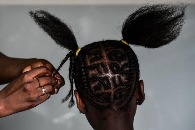 A young girl has had her hair braided in a complex pattern during the 13th contest of Afro hairdressers. (LUIS ROBAYO / AFP) 