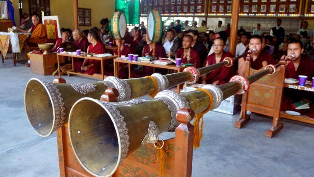 Exiled Tibetan Buddhist monks blow ceremonial horns during a special morning-prayer session on the occasion of 82nd birthday of Dalai Lama at a monastery in Mcleodganj, near Dharamsala on Thursday.  (Shyam Sharma/HT Photo) 