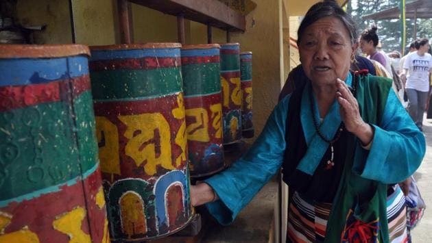 Exiled Tibetans rotates a Buddhist prayer wheel at Tsuglhakhang temple on the occasion of 82nd birthday of Dalai Lama  at a monastery in Mcleodganj, near Dharamsala on Thursday.  (Shyam Sharma/HT Photo) 